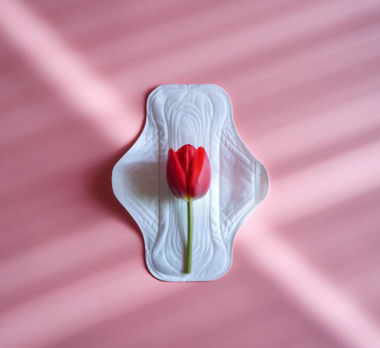 Minimalist feminine hygiene concept representing the menstrual cycle and its impact on hormonal acne and monthly skin breakouts.