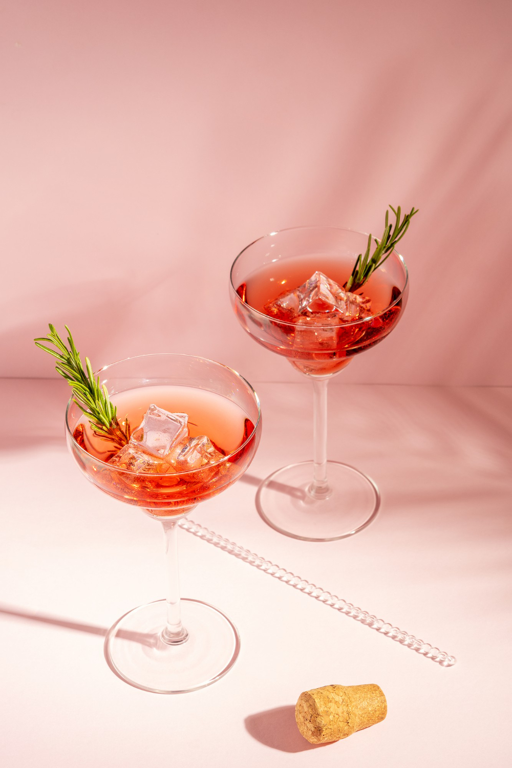 Pink cocktails with rosemary garnish — how alcohol affects hormonal acne and aging skin