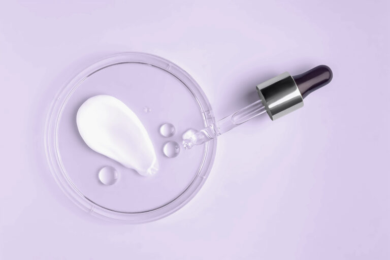 Azelaic acid cream and niacinamide serum droplets side by side for oily, hormonal skin